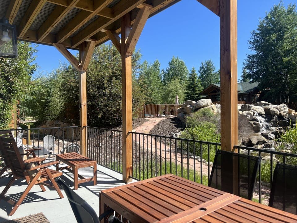 Back deck view towards neighborhood pool & waterfall.  Table expands to seat 10