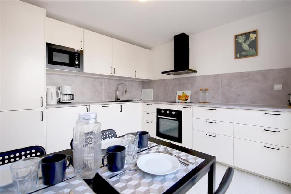 Modern kitchen fully fitted with dining area for four guests