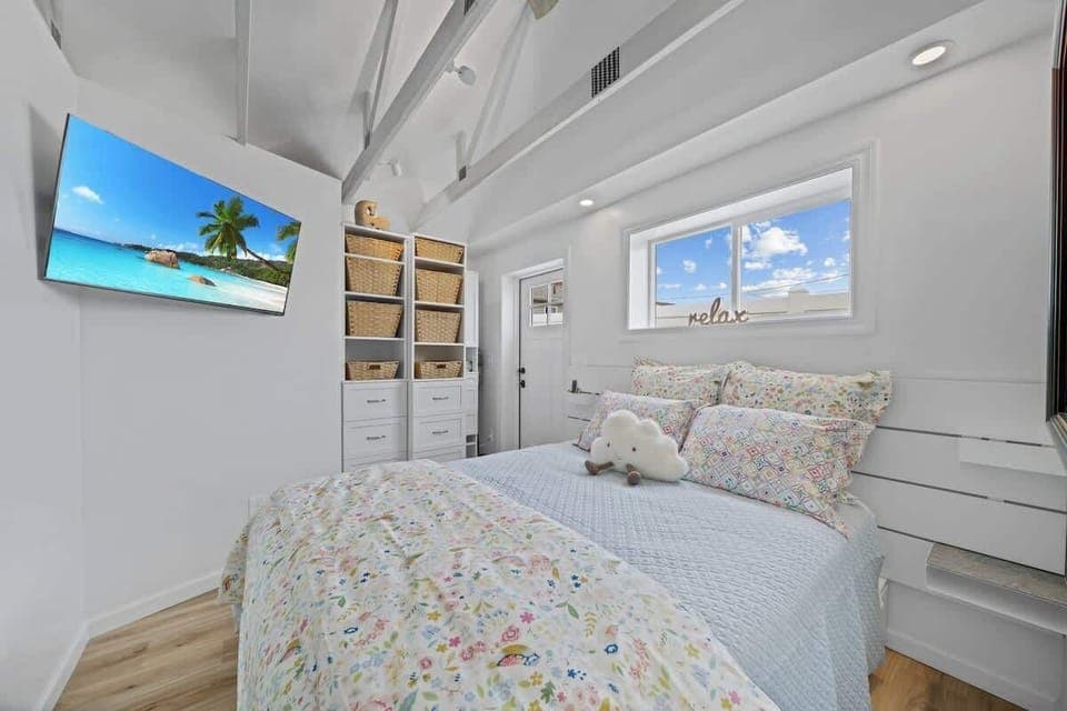 Cozy and inviting bedroom featuring a comfortable queen-size bed with fresh linens, soft pillows, and a flat-screen TV for your relaxation and entertainment.