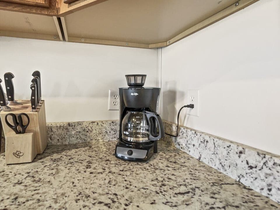 There is a drip coffee pot in the condo