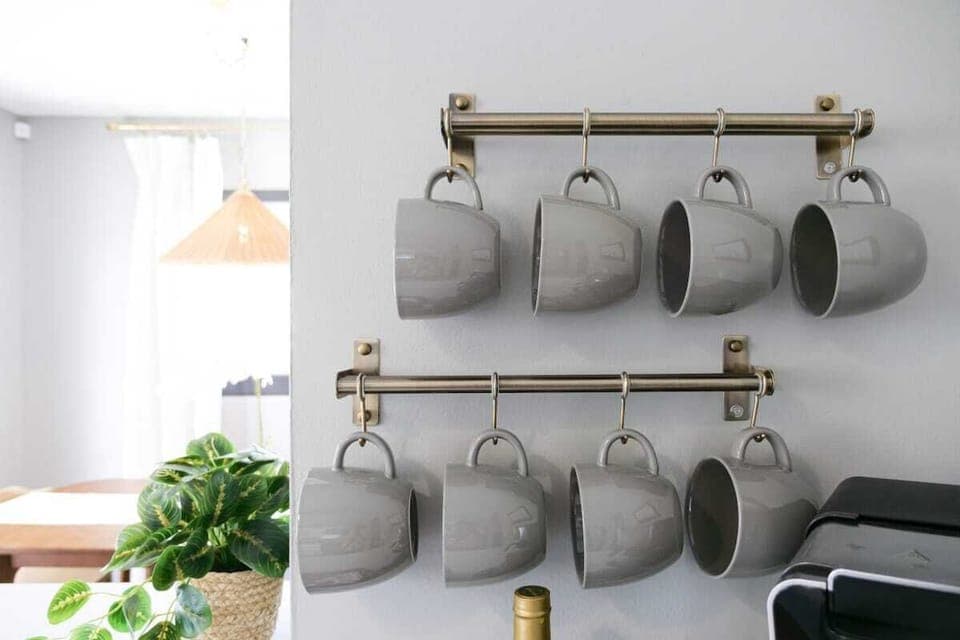 - Mug rack with neatly arranged cups above coffee maker   - Stylish and functional setup for the kitchen station   - Ready for fresh brews anytime during your stay  