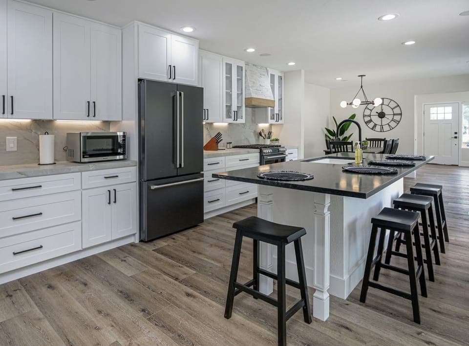 Remodeled kitchen fully stocked with dishes, glasses, cookware, silverware  