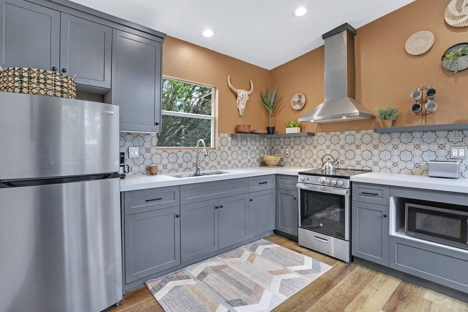 The cabin has a modern kitchen with stainless range/oven combo.