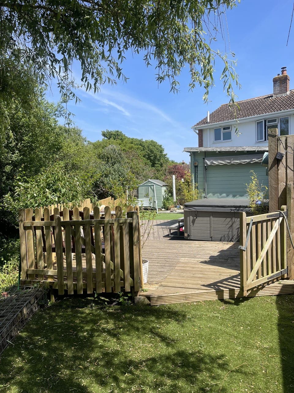 DaneSide from end of garden, under the willow, with hot tub and summer room.