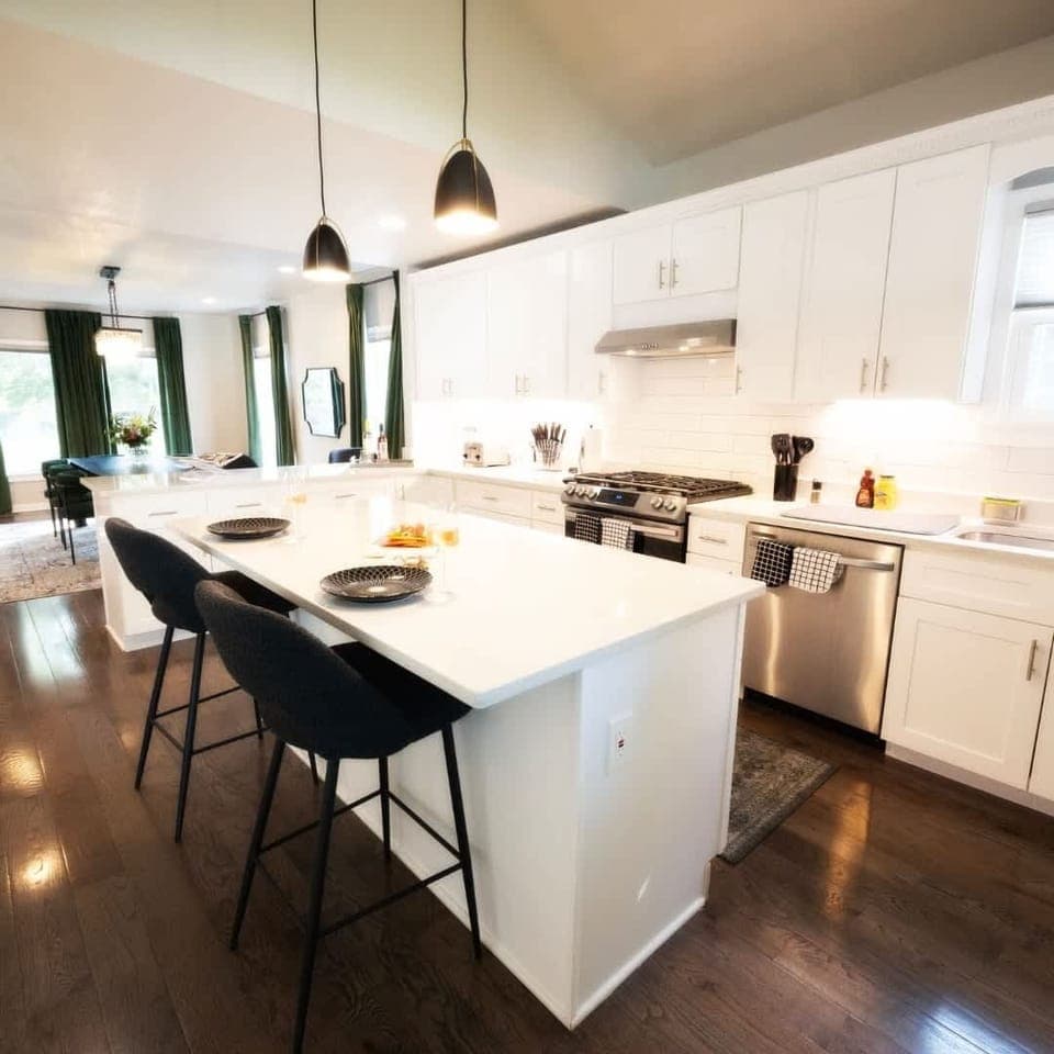 Modern casual dining in our vacation home—sleek, minimalistic design with a touch of comfort. Enjoy meals around the contemporary dining table or casual bites at the bar, all while soaking in the chic atmosphere of your Cleveland getaway.