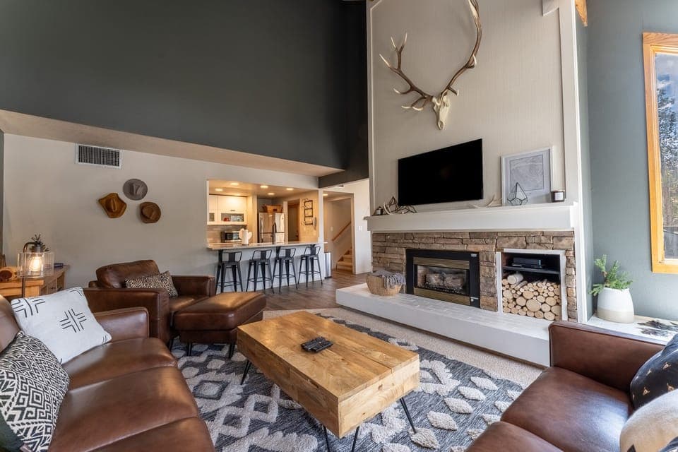 Living area offering cozy furnishings, valued ceilings and a gas fireplace.