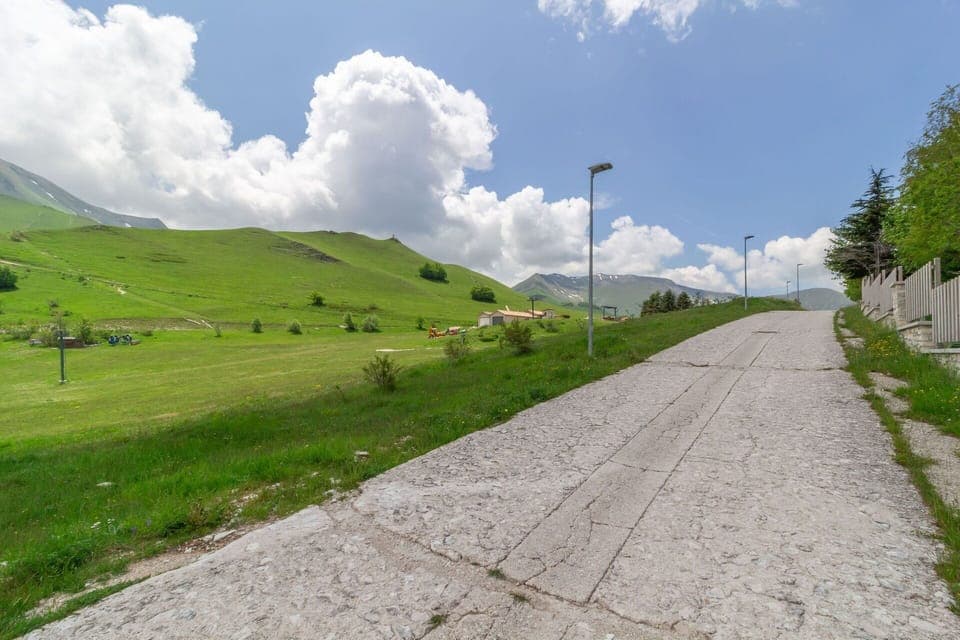 Cloud, Sky, Plant, Mountain, Natural Landscape, Road Surface, Asphalt, Land Lot, Slope, Street Light