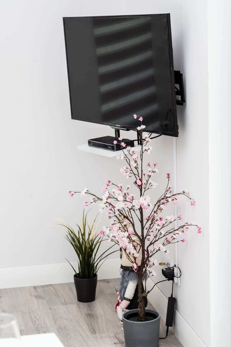 A decorative vase with flowers adding a natural and stylish touch to the minimalist interior.
