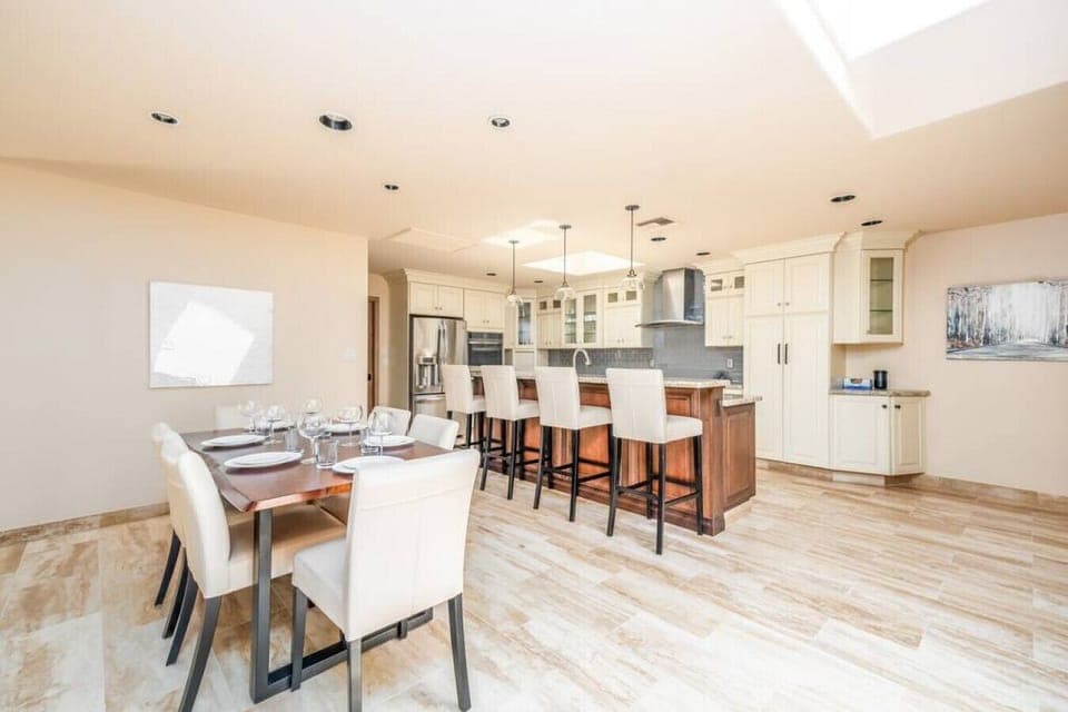 Bright kitchen with breakfast bar, granite countertops, and seamless flow for entertaining.