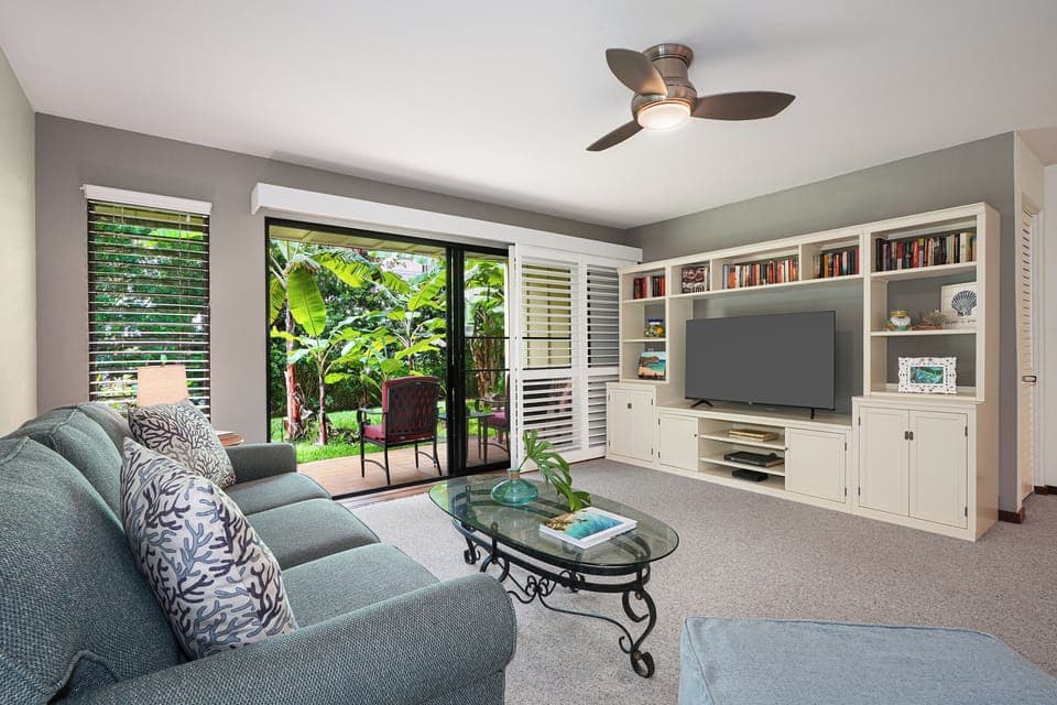 Seamless indoor-outdoor living: a spacious living area seamlessly connects to the lanai, inviting the outdoors in.
