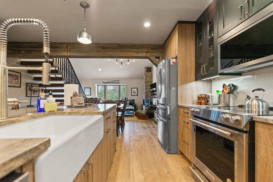 Kitchen island with bar stools offers seating for meals and drinks.