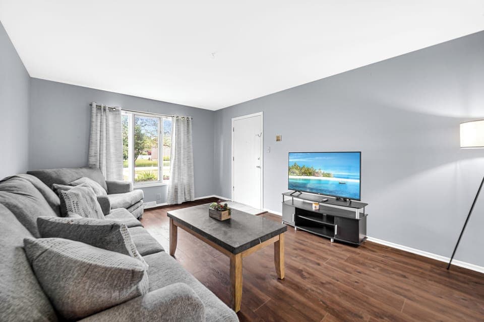 Living room with brand new couch and over sized chair (1)