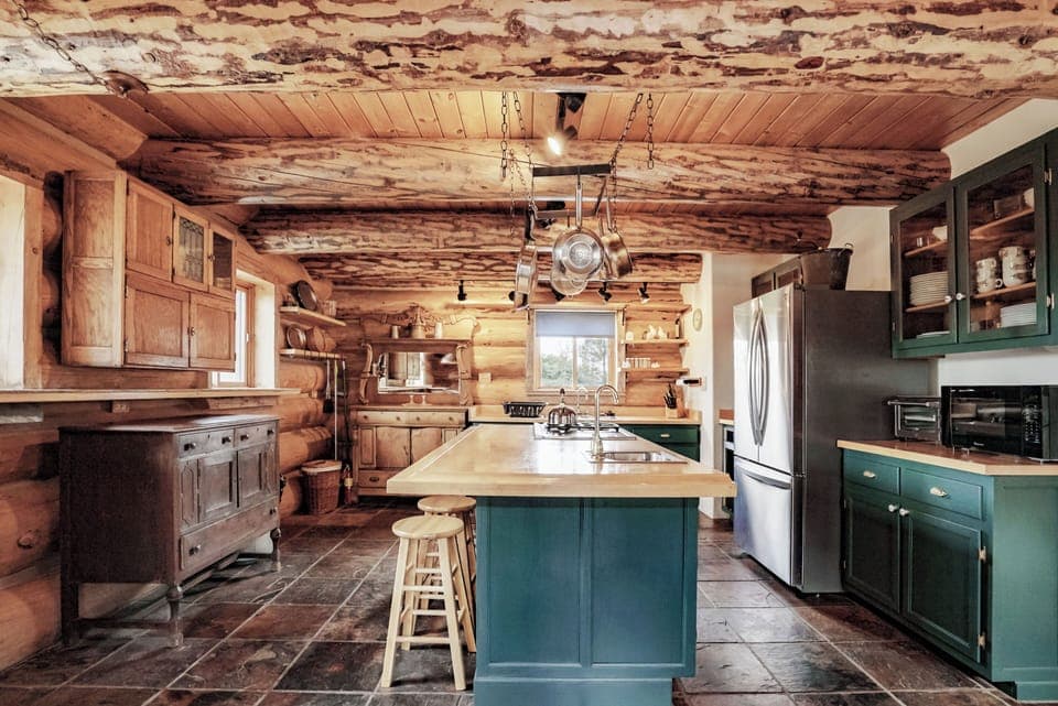 Stocked kitchen with 4 burner gas stove, oven, fridge/freezer, and dishwasher