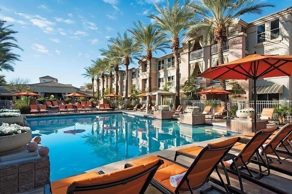 Dive into resort-style relaxation beneath swaying palms and sunshine.