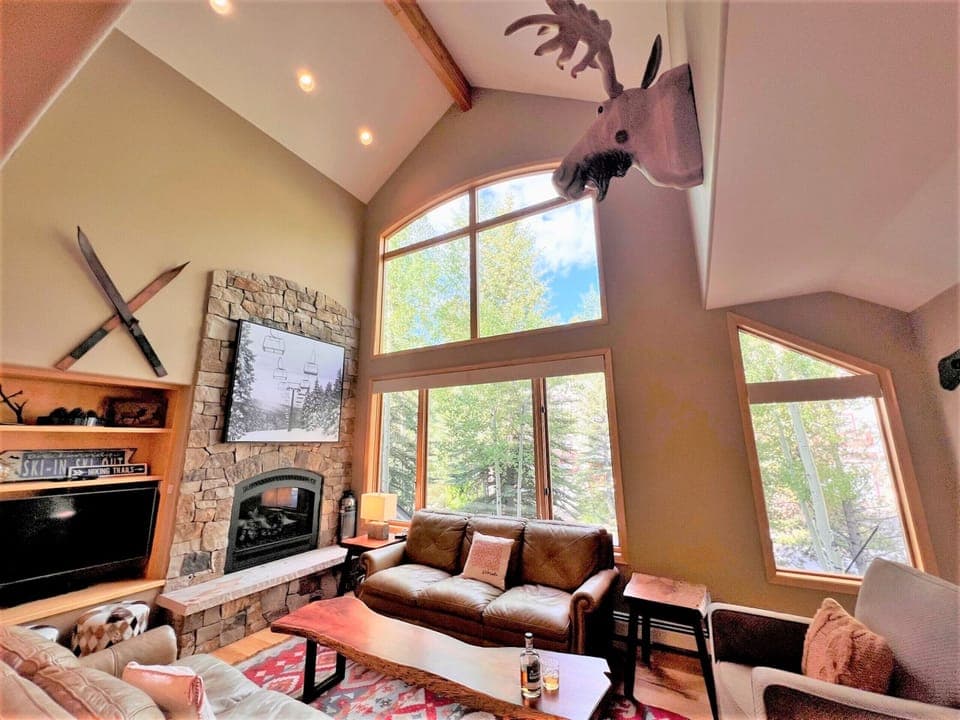 Great room with floor to ceiling windows and plenty of comfy seating