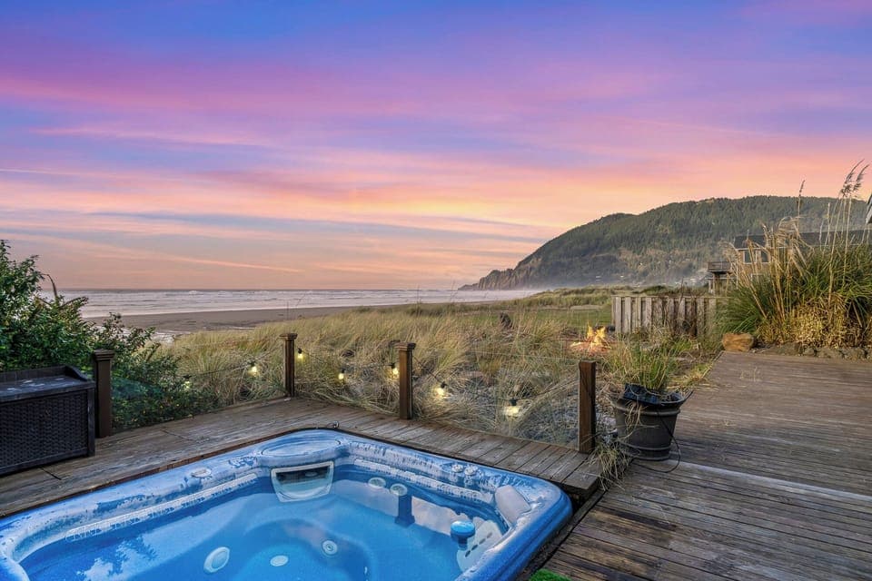 hot tub and firepit facing the ocean and mountains.