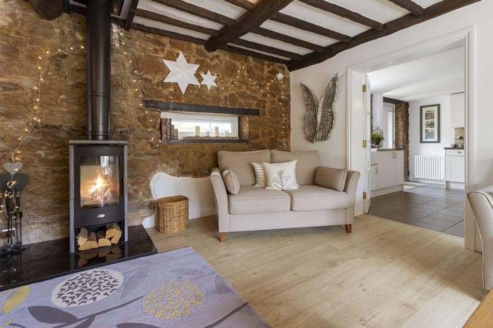 Open plan lounge and dining room with wood burning stove