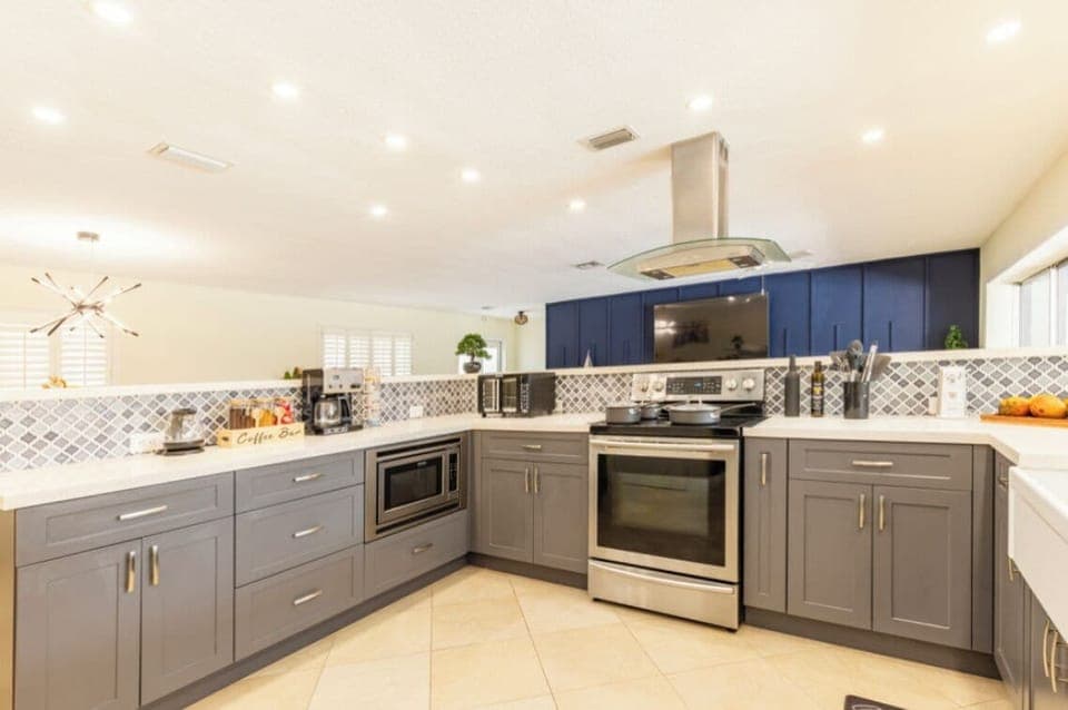 Open kitchen with stove, coffee maker, toaster