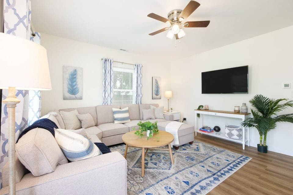 Bright, airy, and beautifully styled 🌿☀️ This cozy living room features a comfy sectional, smart TV, and calming coastal touches—perfect for movie nights or morning coffee vibes 📺☕