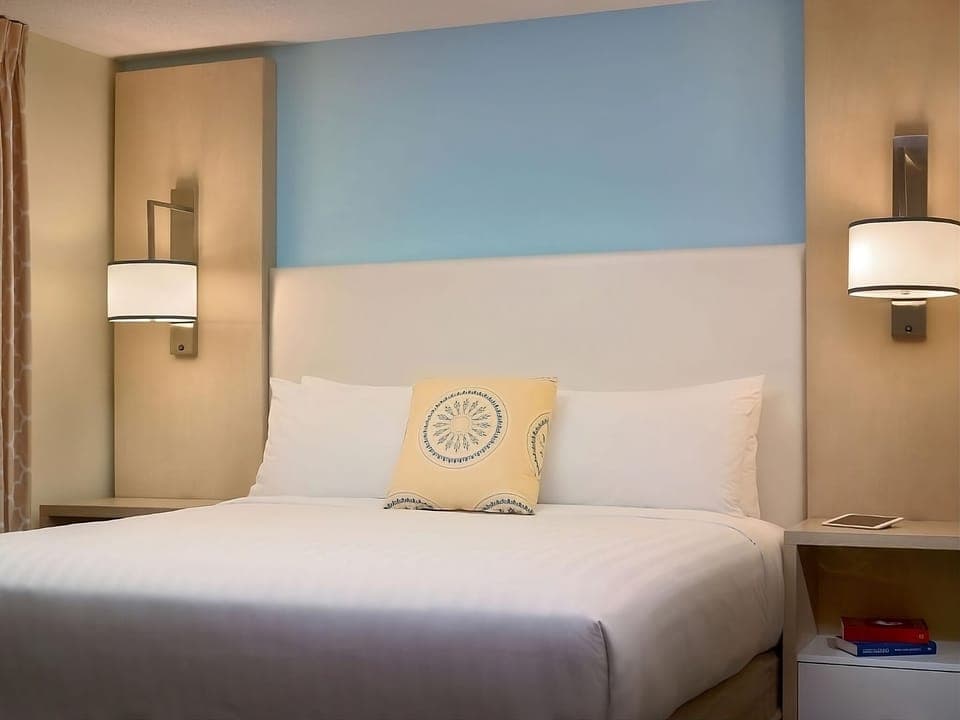 Sink into plush pillows beneath warm bedside lighting each night.