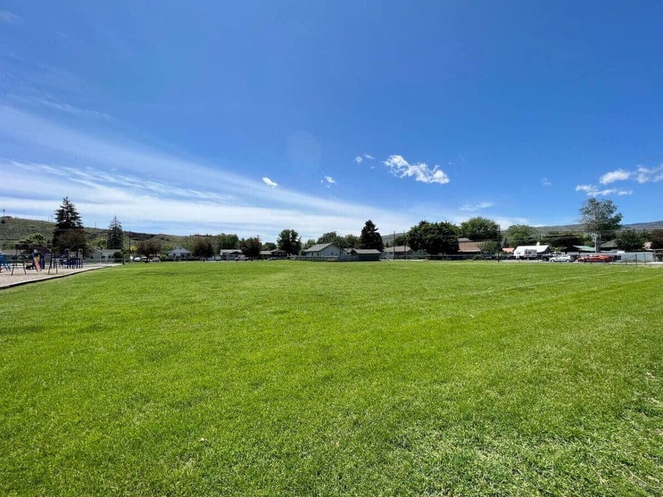 Nestled beside Brooklyn elementary school with a large field