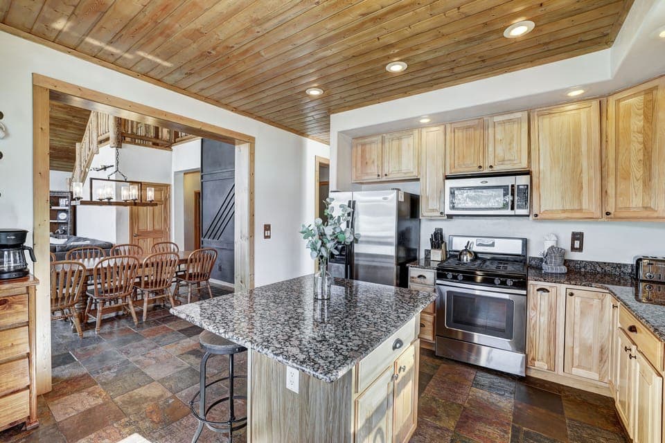 Modern kitchen with granite counters and full appliances.