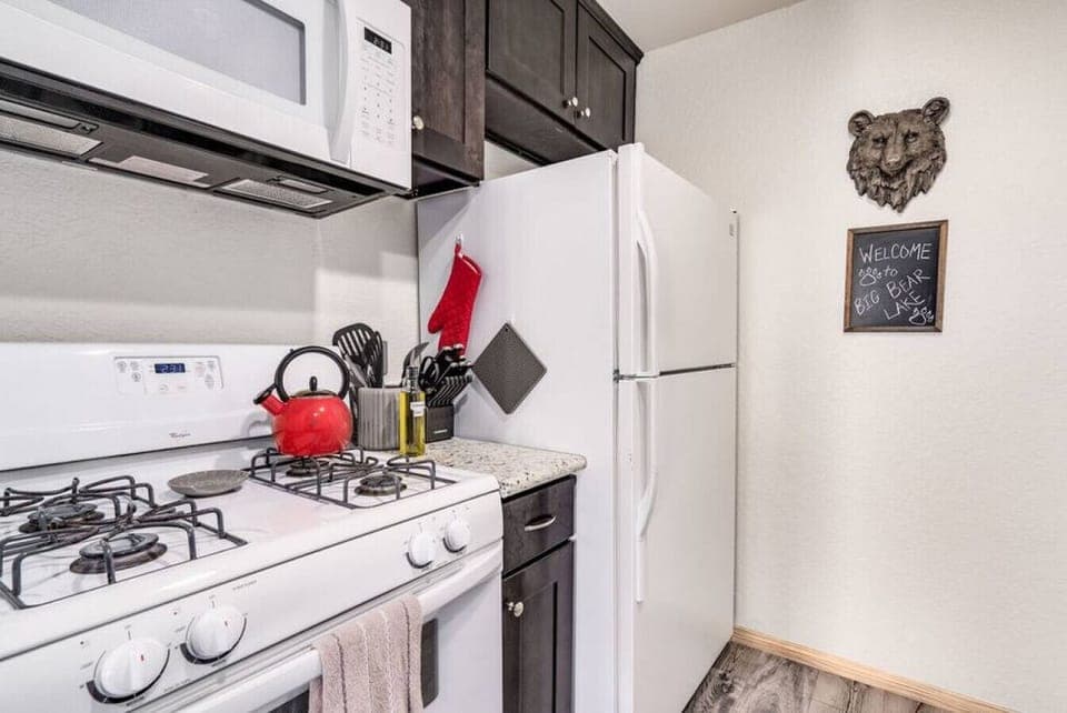 A nice modern open concept kitchen welcomes you to Big Bear Lake.  The Kitchen is fully stocked with everything you need even a cute red teapot to brew yourself a nice cup of luxury tea.