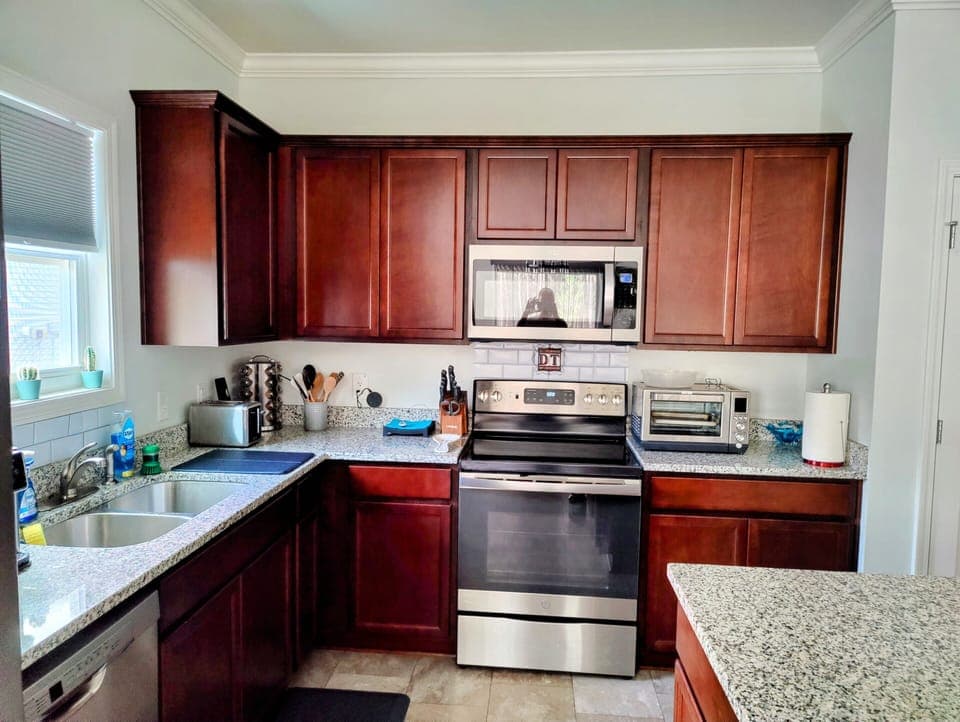 full kitchen: fridge, dishwasher, oven, toaster microwave, toaster oven