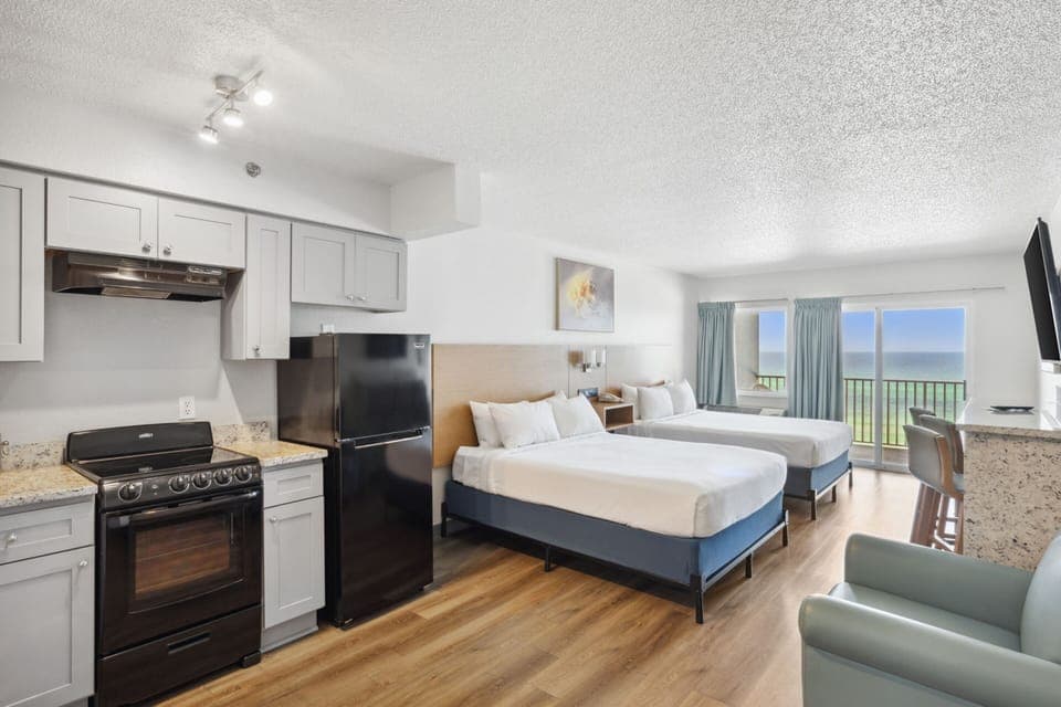Cook simple meals beside cozy beds after a beach day.