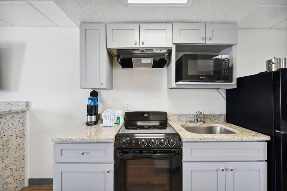 Cook easy meals with stove, microwave, and coffee ready.