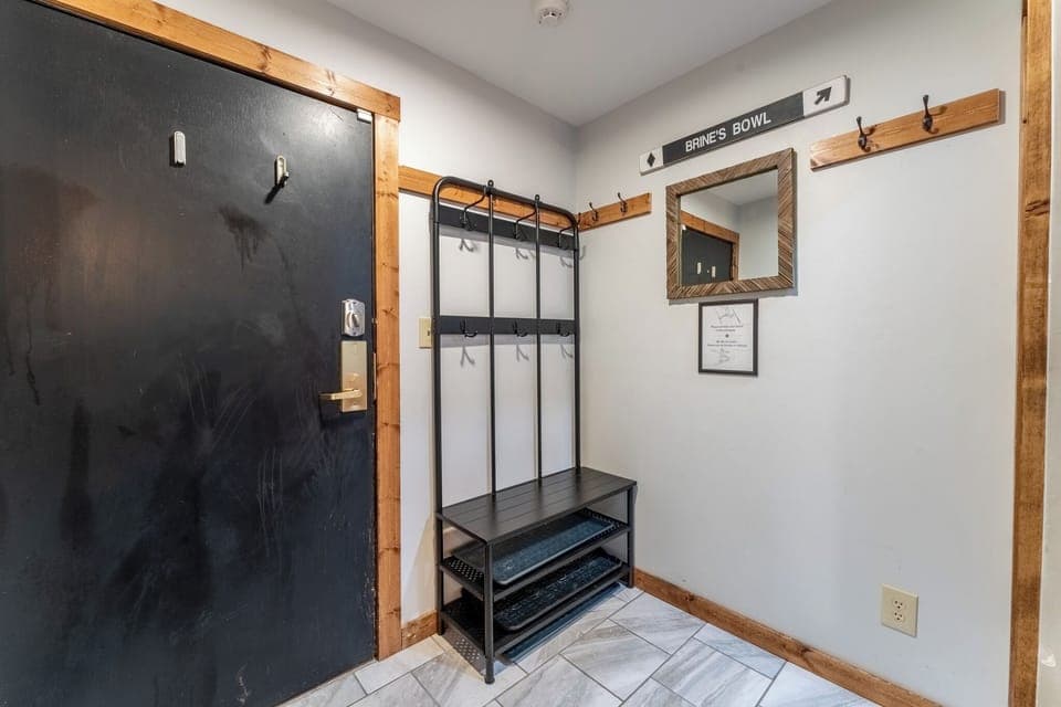 Entryway offering hooks and a bench for easy coming and going throughout the day.