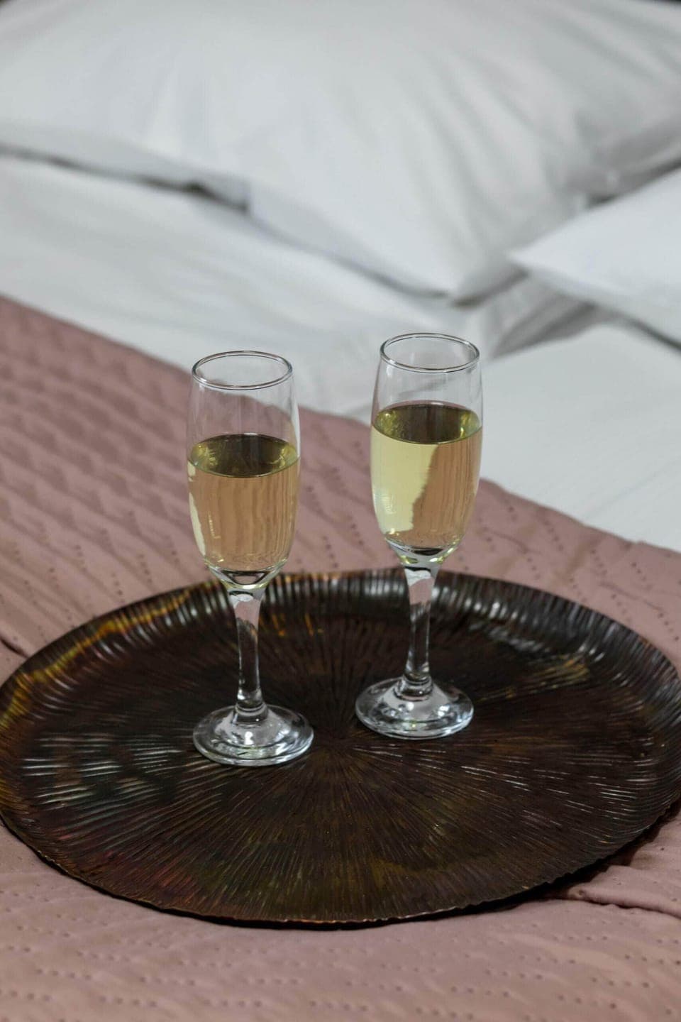A romantic touch with two glasses of champagne served on the bed for special moments.


