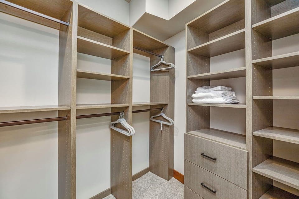 Walk-in closet with built-in shelving and ample storage for extended stays