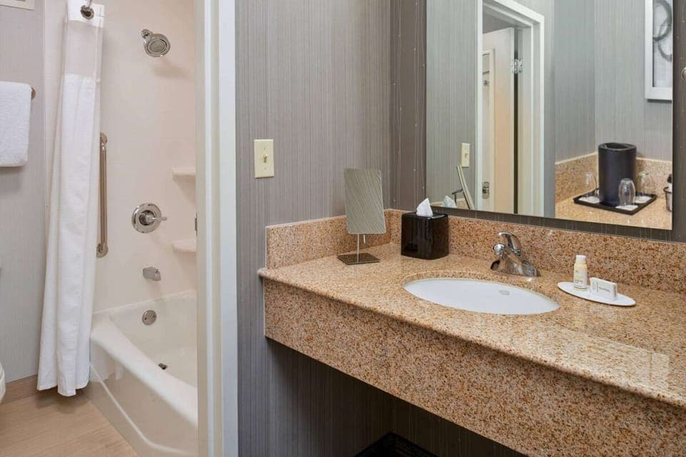 Freshen up with a roomy vanity and clean, bright bath.