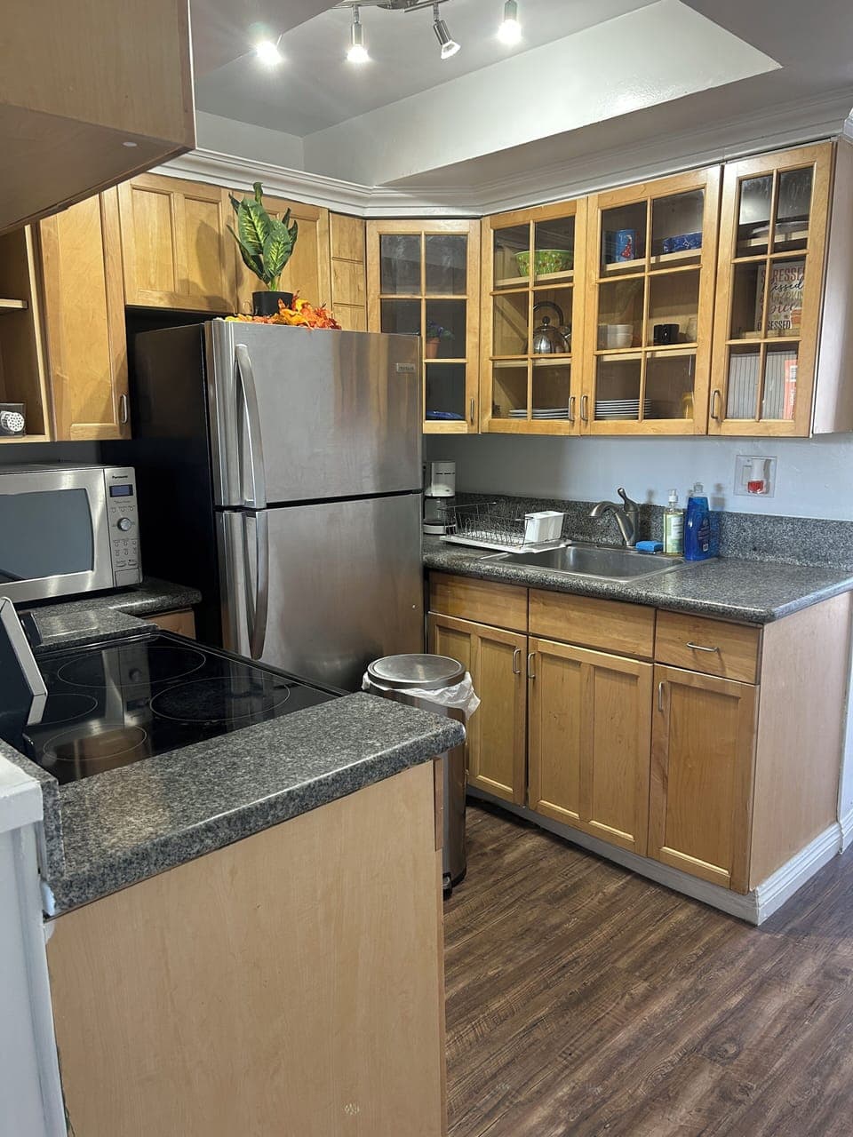 Full kitchen with cookware and utensils, refrigerator, microwave, stove and oven