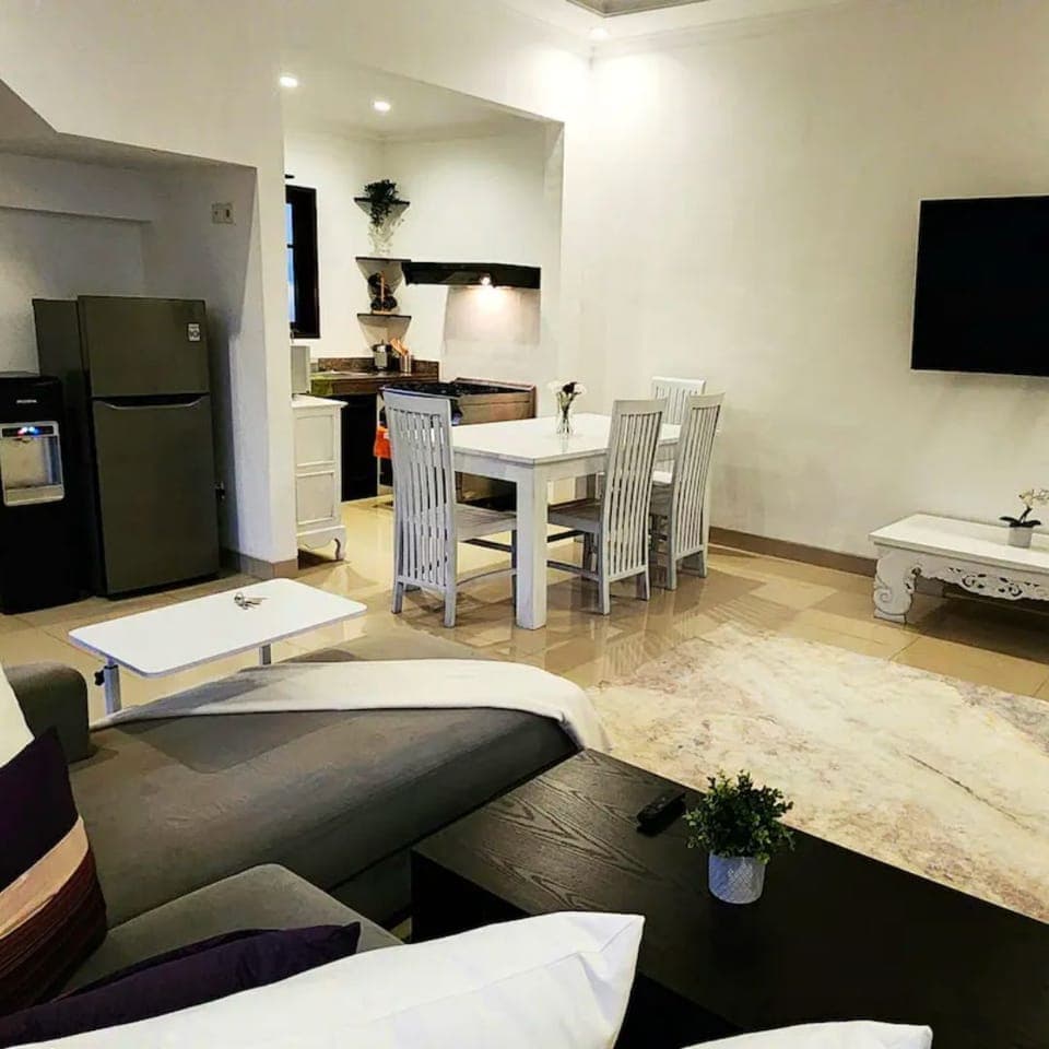 Comfy sofa with oversized pillows & 65 Inch Curved Samsung tv to enjoy. 