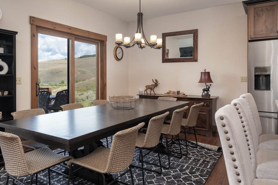 Seating for 10 at dining table with additional seating at the bar.