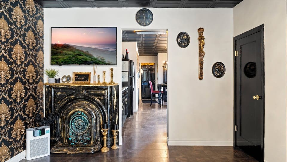 Glossy black kitchen with gold hardware and modern appliances