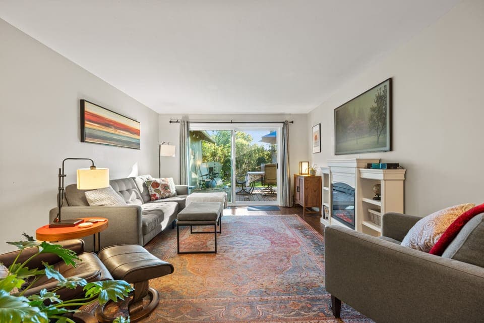 Bright living room with oversized sliding glass door and cozy fireplace