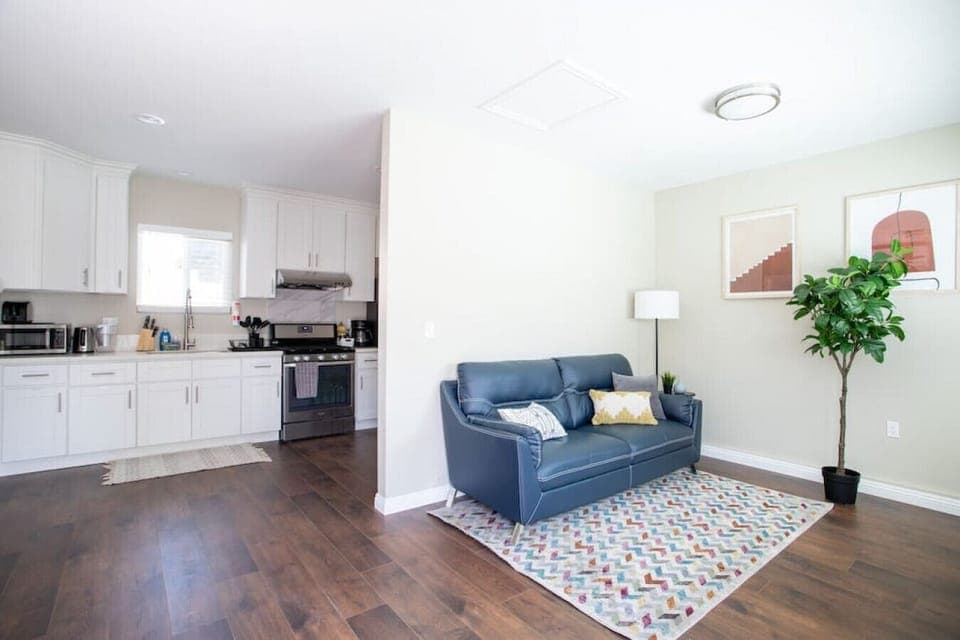 Kick back and relax in our cozy and inviting living room, complete with a comfortable sofa and widescreen TV.