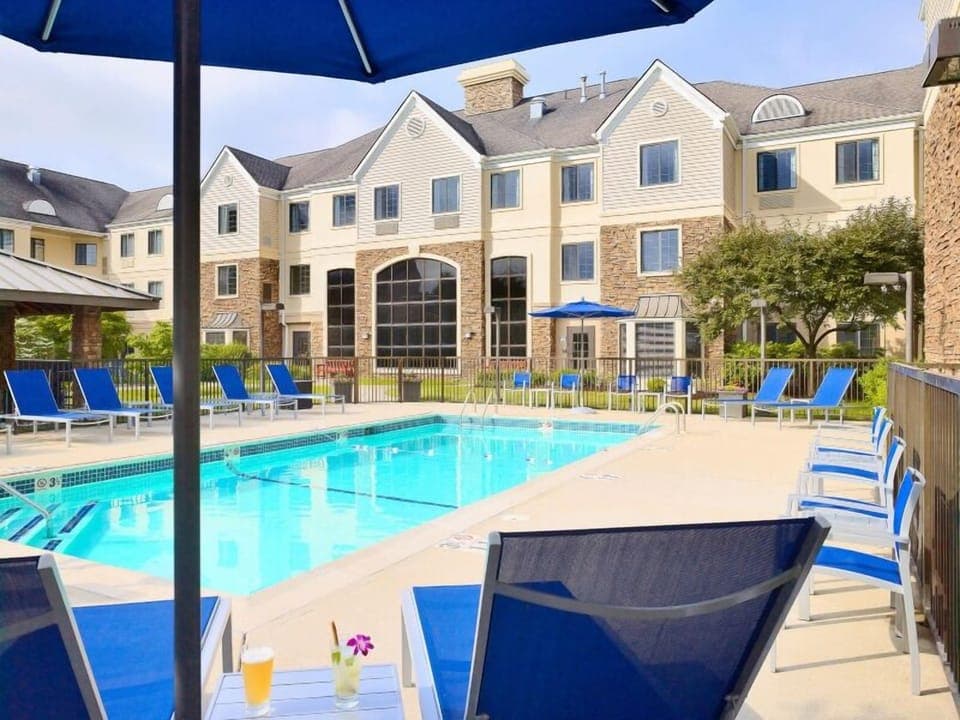 Unwind poolside on bright loungers under sunny umbrellas.