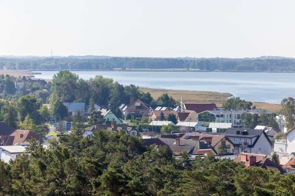 A scenic view of a residential area with a mix of modern architecture and natural surroundings.

