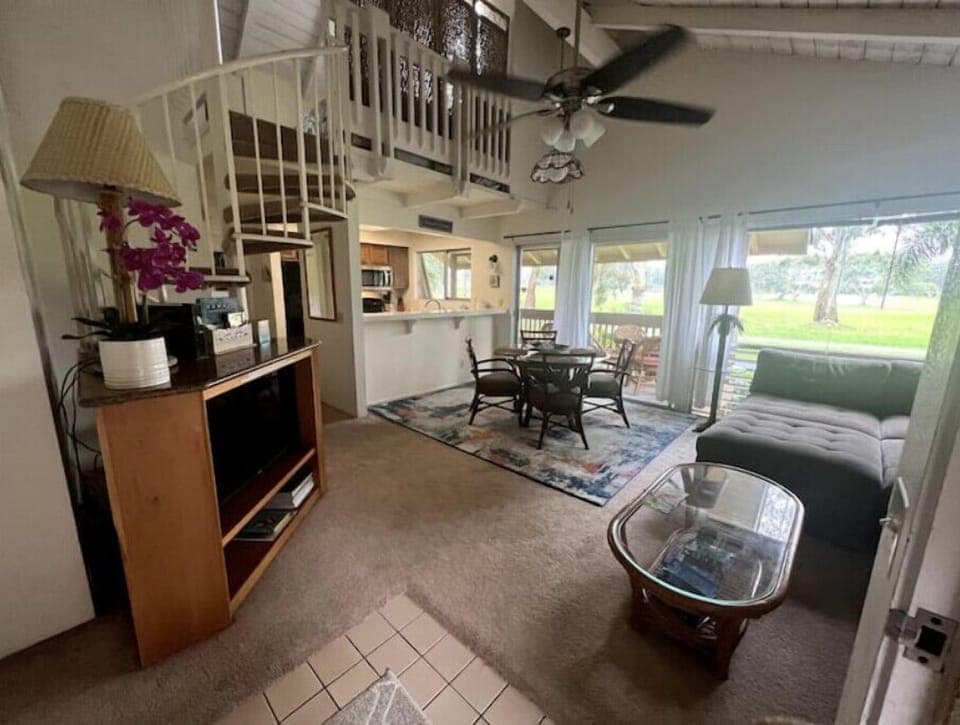 Living/dining room area with sectional, table for 4, and Roku TV