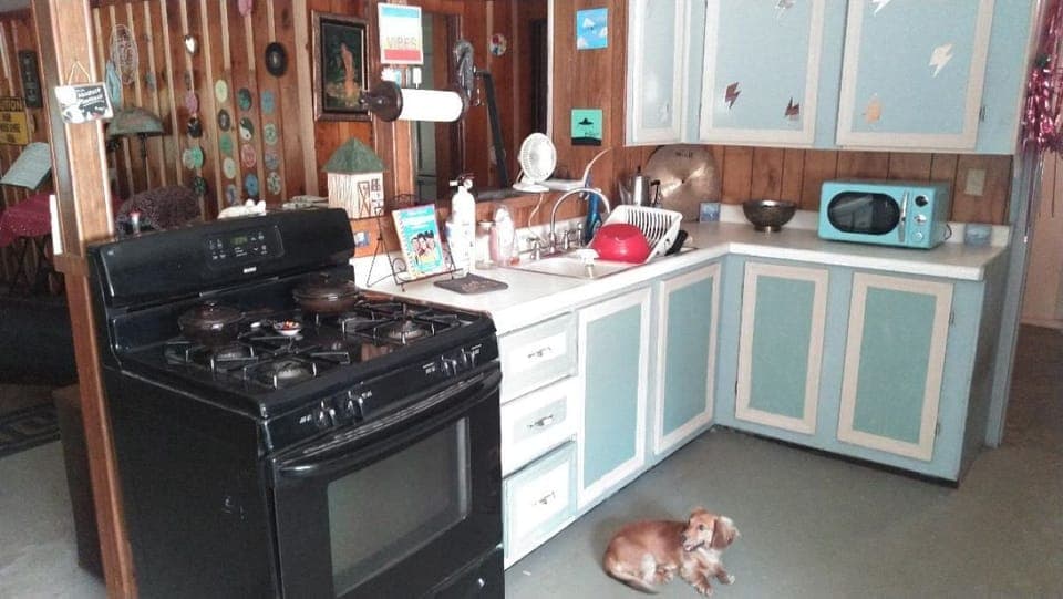 Kitchen with microwave, toaster, and coffee pot. 