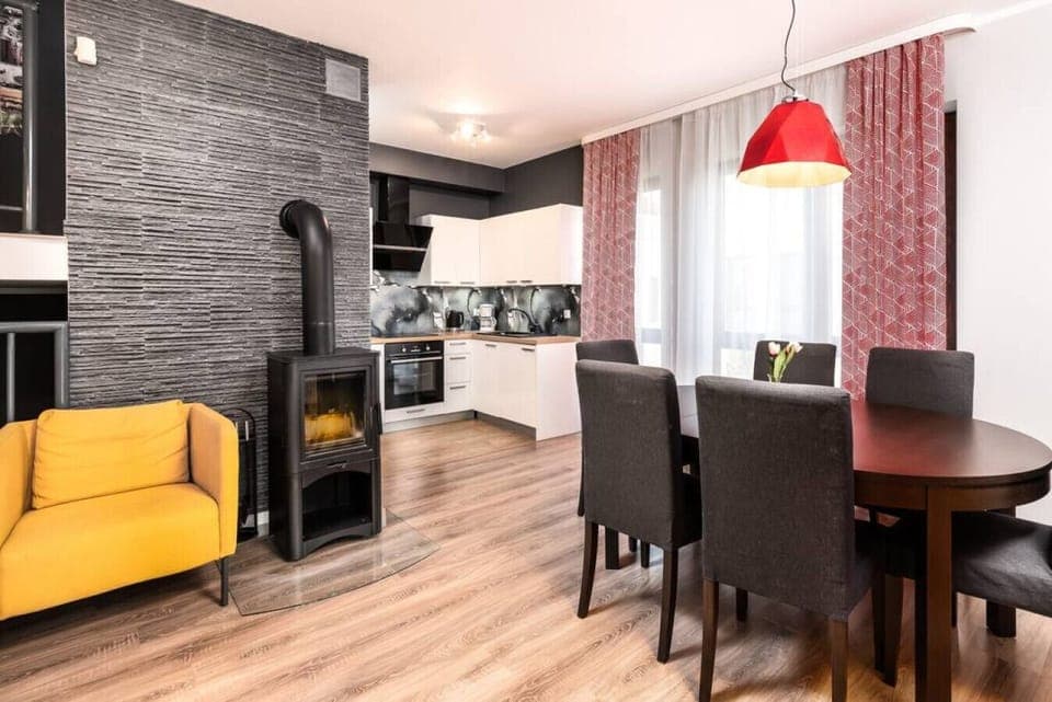 Cozy dining room with fireplace – a seaside luxury apartment full of charm.