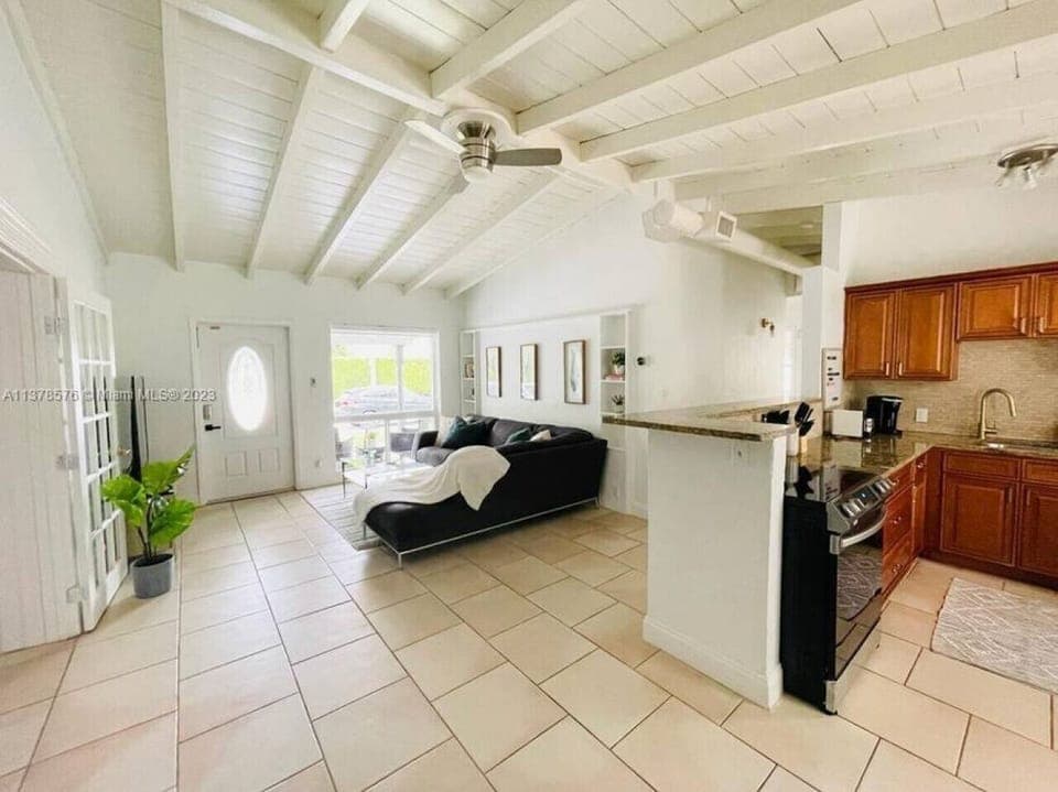 Open-Concept Living: Our living room seamlessly flows into a well-equipped kitchen, making it perfect for socializing.