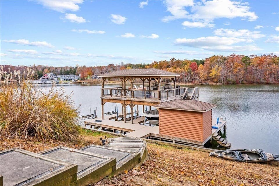 Impressive boat dock that features an amazing partially covered dock with a grill, smart TV, and lovely views of Lake Anna