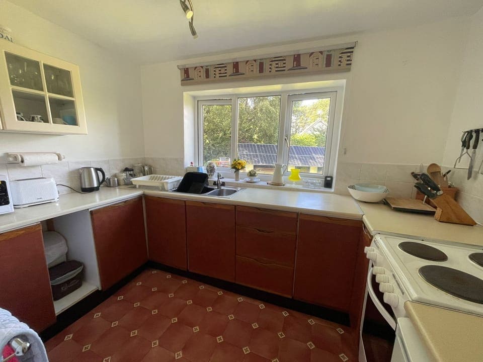 Kitchen with accessories including cooker, fridge, microwave, kettle, toaster...