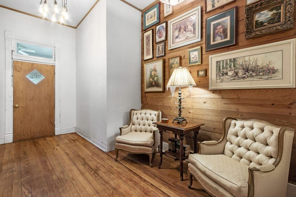 The custom gallery wall contains a variety of photos from different decades.