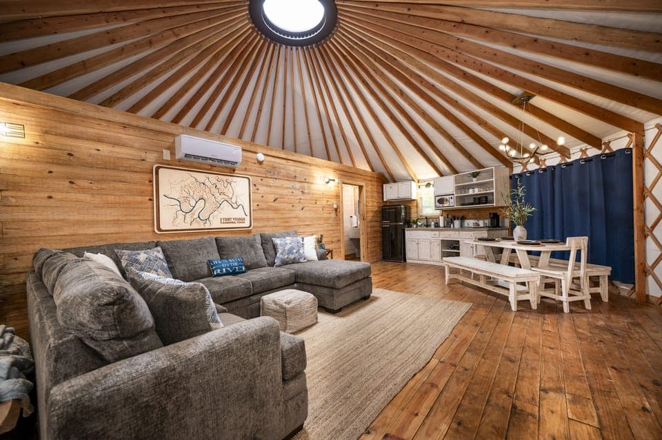 Such a cozy space with beautiful wood and natural light from the Yurt design.